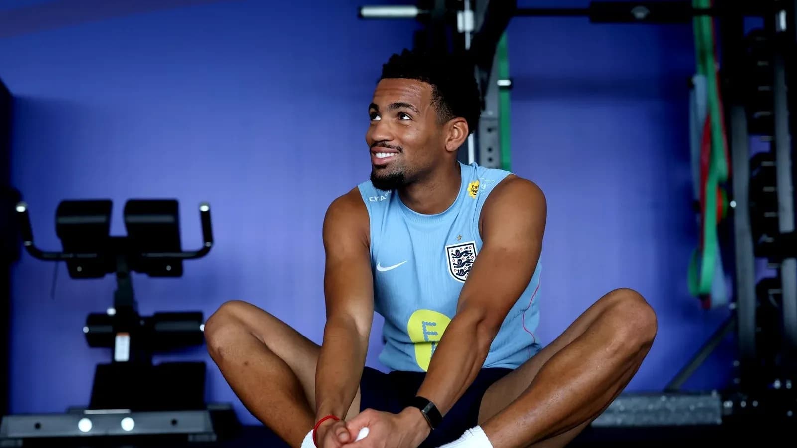 Athlete stretching in training facility gym Athlete stretching in training facility gym