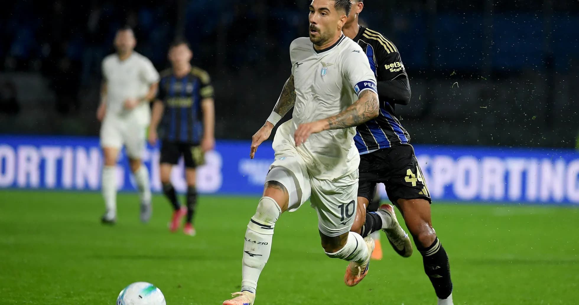 Lazio player dribbling against Pisa defender Lazio player dribbling against Pisa defender