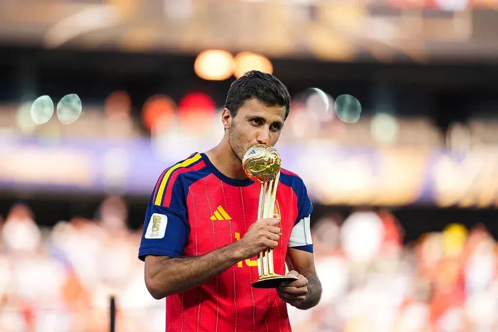 Player kissing FIFA World Cup trophy on field Player kissing FIFA World Cup trophy on field