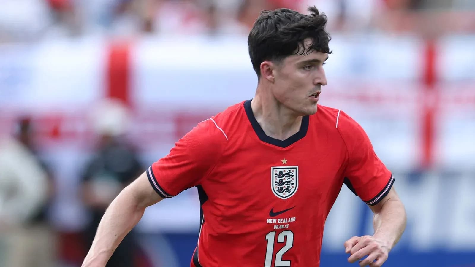 Player in red England jersey running during match Player in red England jersey running during match