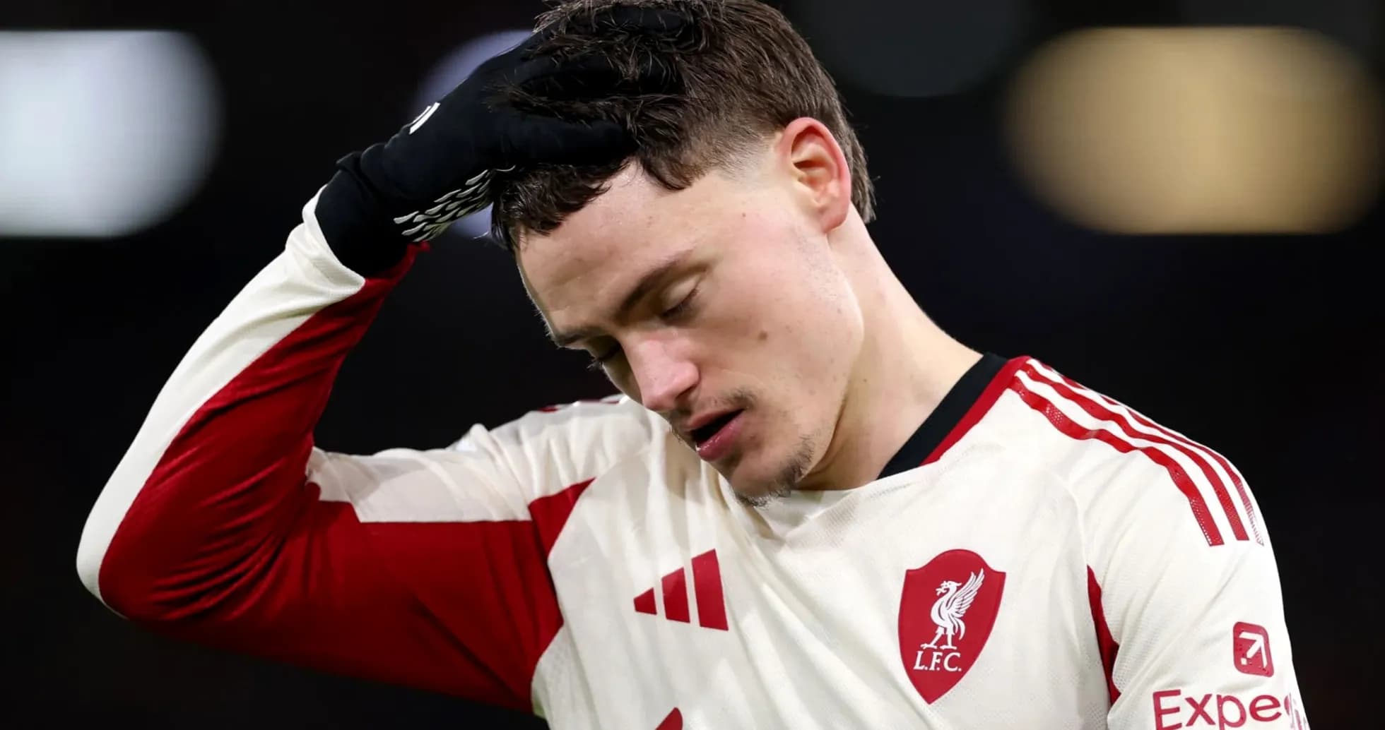 Player in Liverpool kit with hand on forehead Player in Liverpool kit with hand on forehead