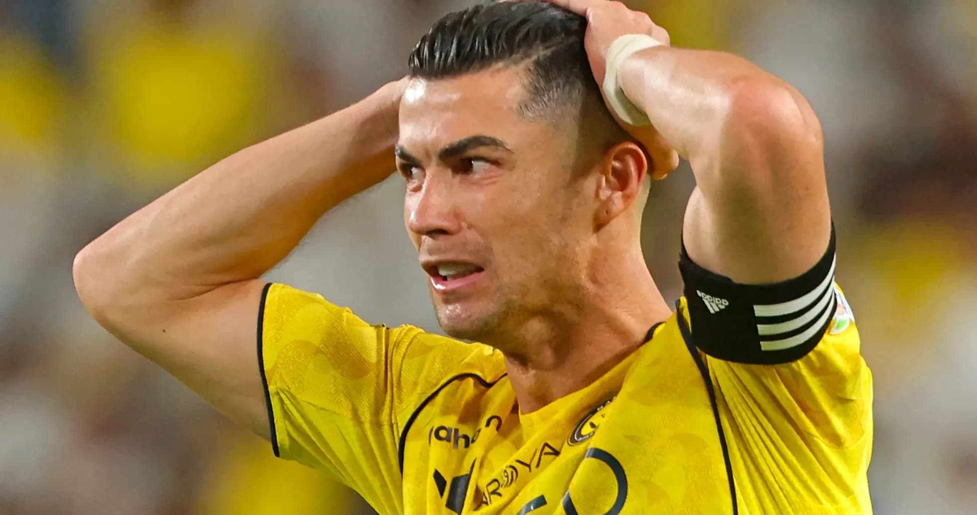 Player in yellow jersey holding head in frustration Player in yellow jersey holding head in frustration