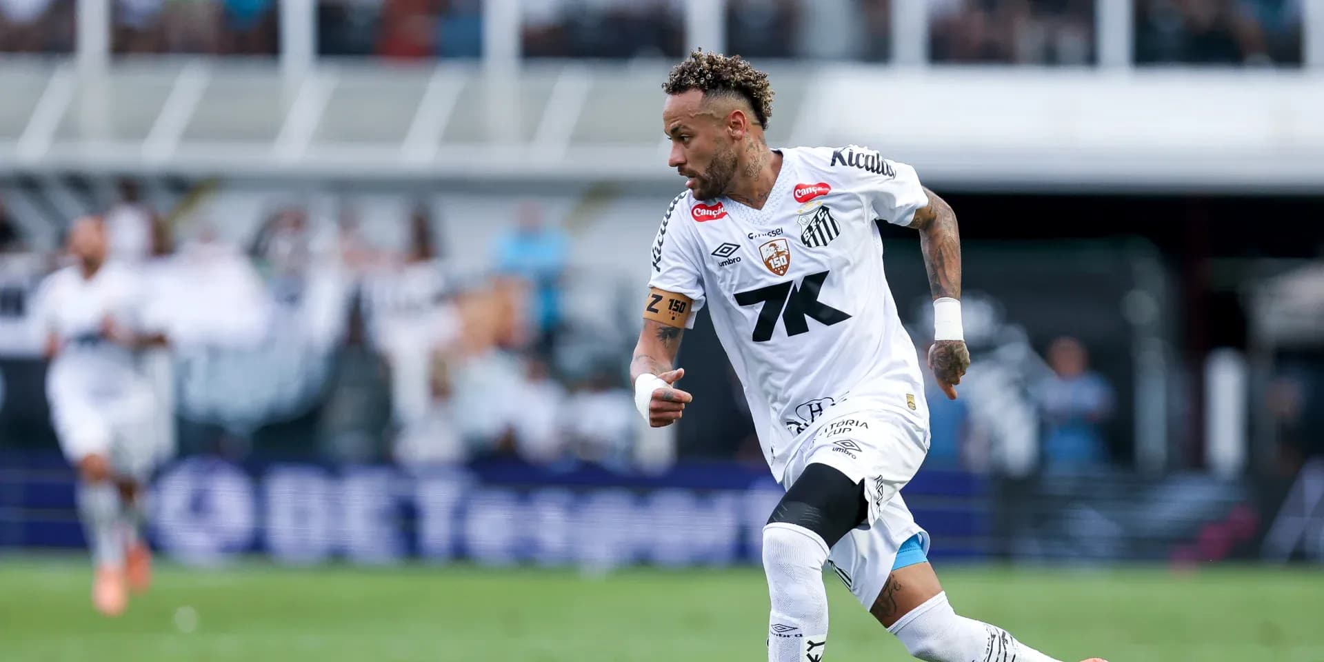 Player in white jersey running during match Player in white jersey running during match