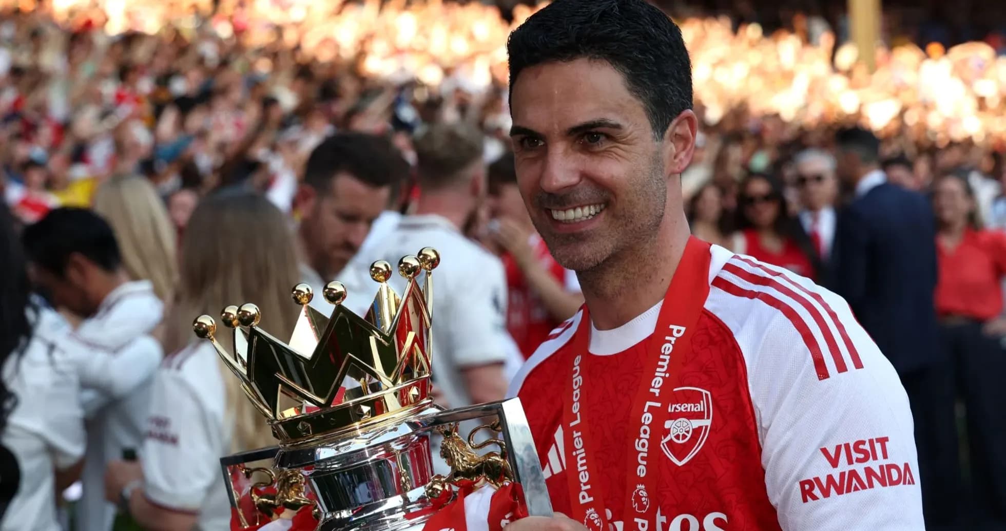 Arsenal manager holding Premier League trophy at celebration Arsenal manager holding Premier League trophy at celebration