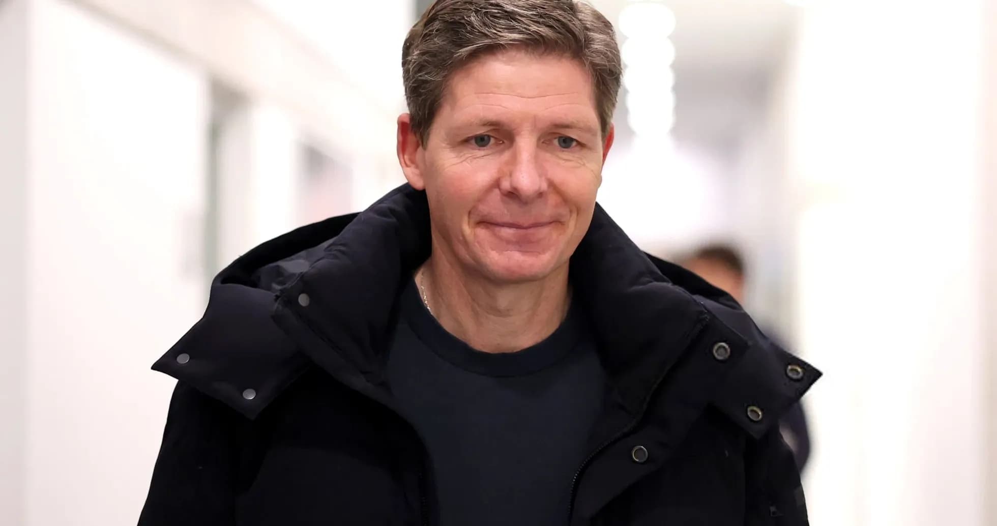 Man walking in corridor wearing a black jacket Man walking in corridor wearing a black jacket