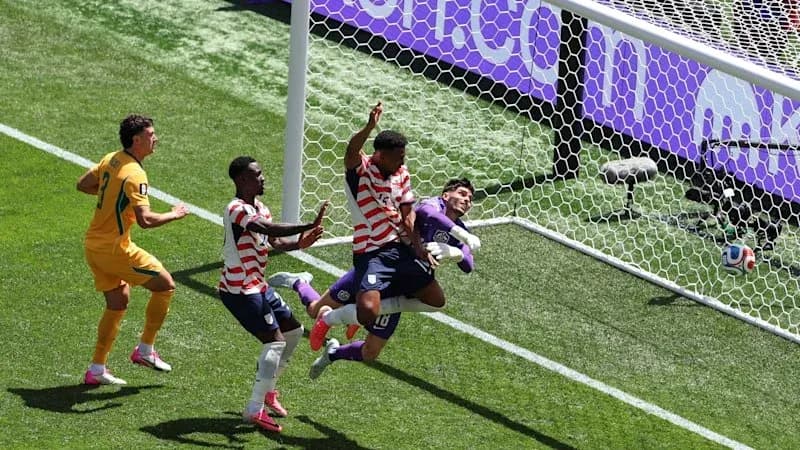 Players competing near goal during soccer match Players competing near goal during soccer match