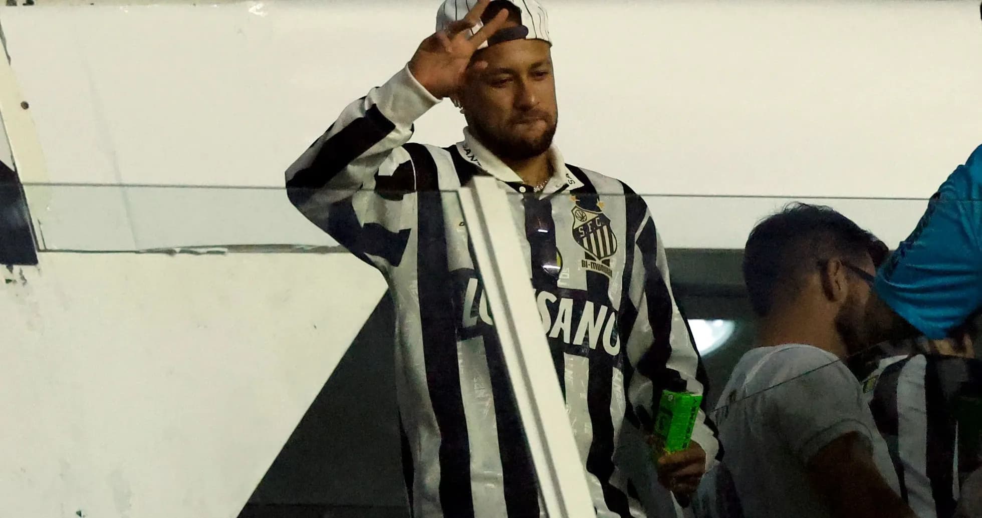 Fan waving in Santos FC jersey at stadium Fan waving in Santos FC jersey at stadium