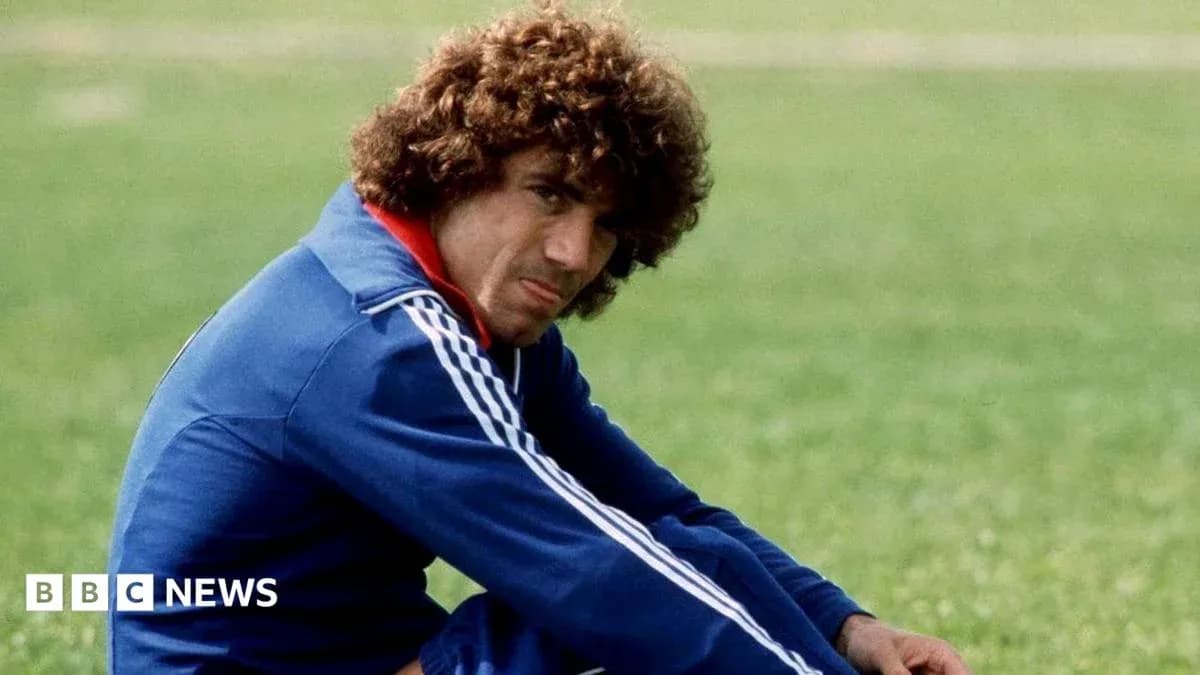 Athlete in blue tracksuit sitting on grass Athlete in blue tracksuit sitting on grass