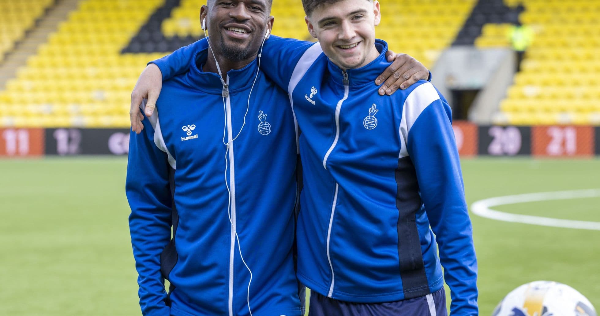 Two players posing together on the pitch Two players posing together on the pitch