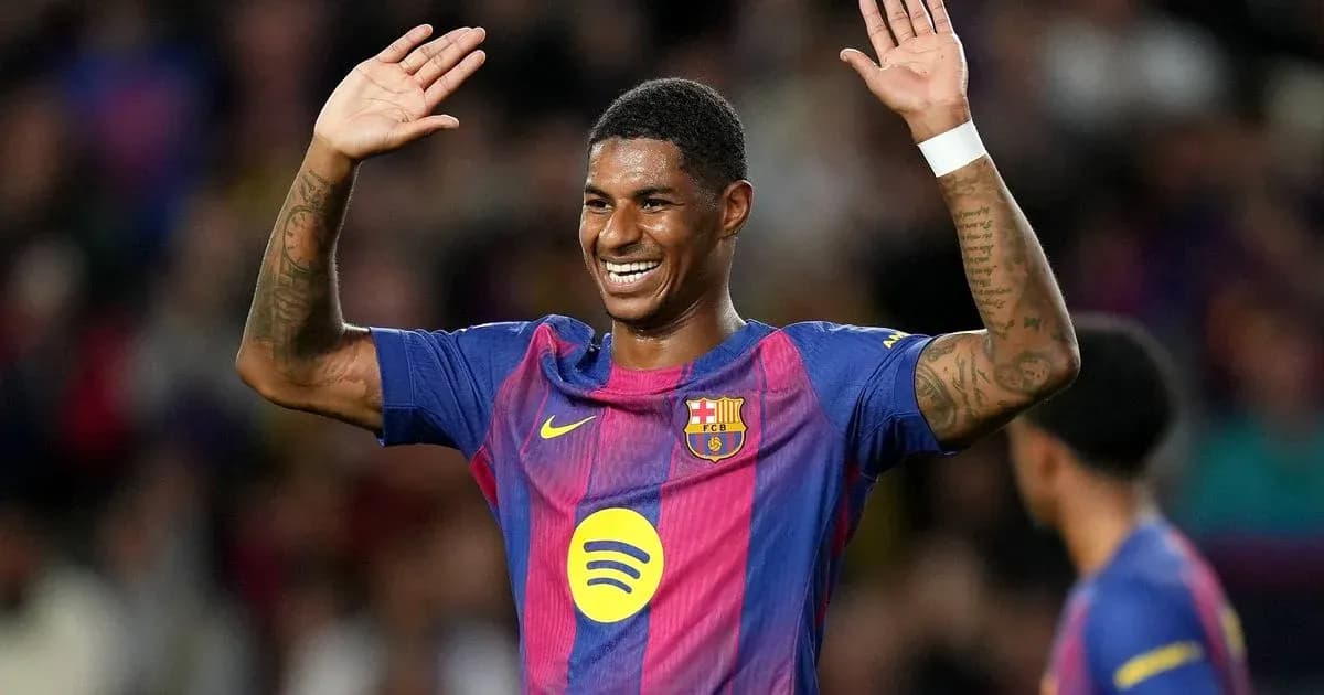 Player celebrating with hands raised on the field Player celebrating with hands raised on the field