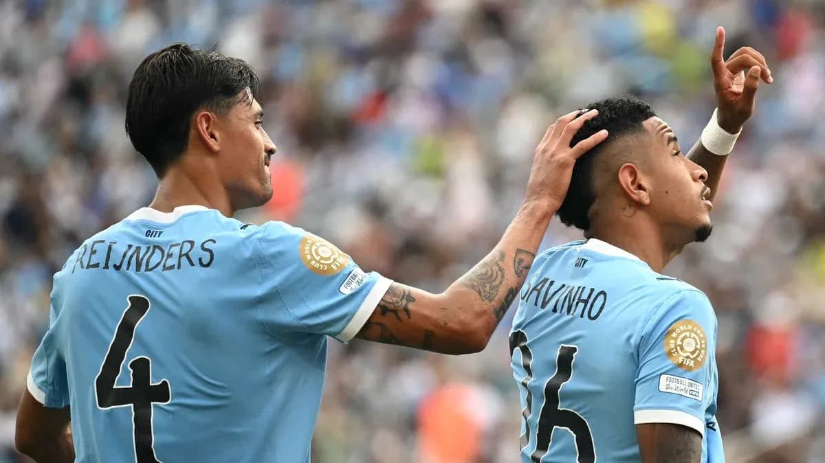Two players celebrating a goal on the field Two players celebrating a goal on the field