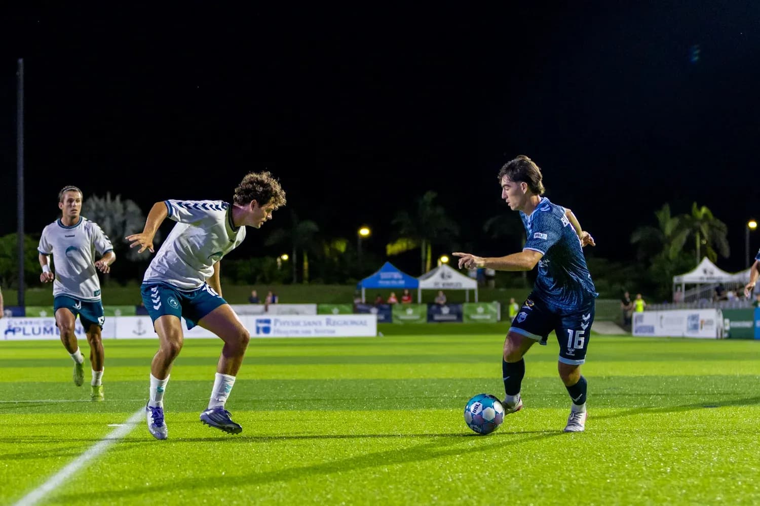 Players competing for the ball during match Players competing for the ball during match
