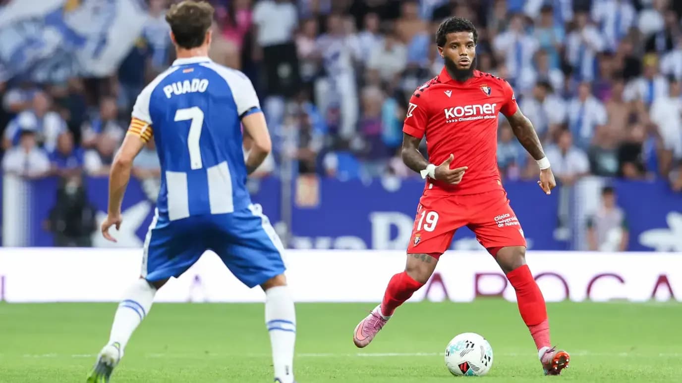 Osasuna player dribbling past Espanyol defender Osasuna player dribbling past Espanyol defender