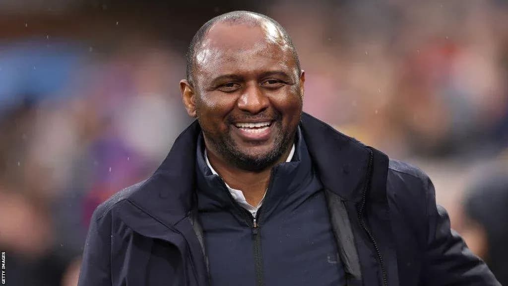 Smiling coach on the sidelines during a match Smiling coach on the sidelines during a match