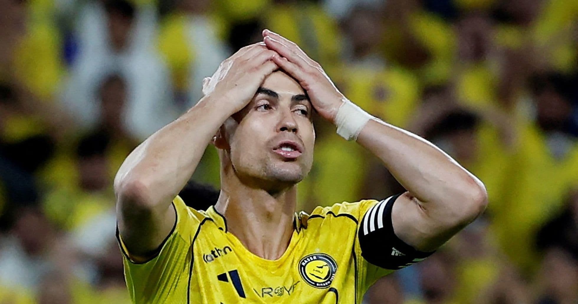 Player in yellow jersey with hands on head Player in yellow jersey with hands on head
