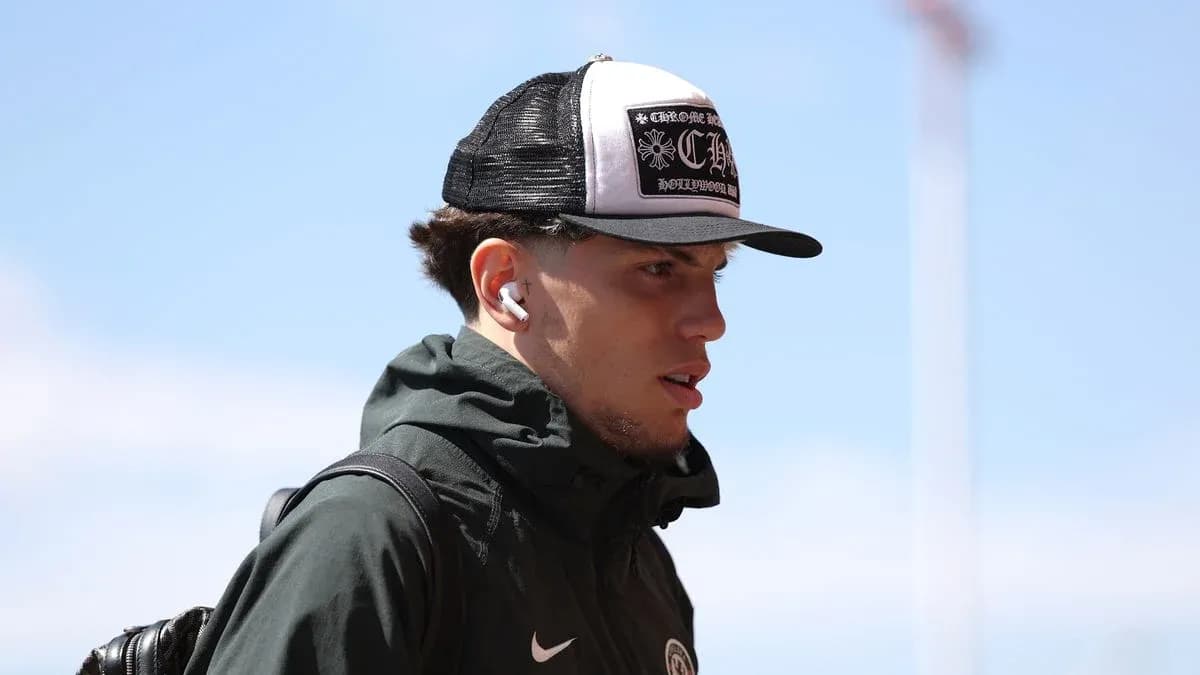 Player wearing a cap and earbuds walking outdoors Player wearing a cap and earbuds walking outdoors