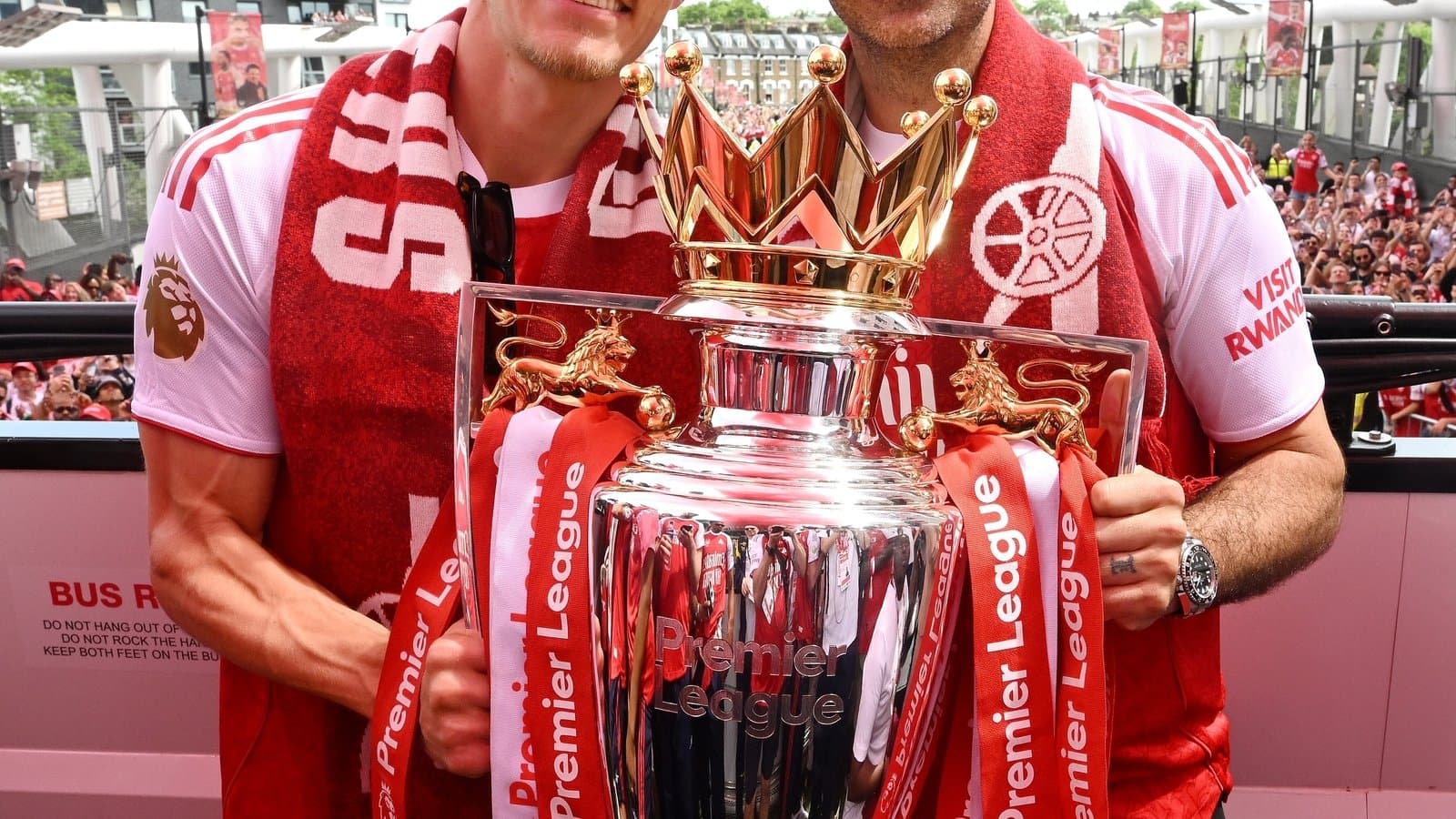 Players celebrating with Premier League trophy on stage Players celebrating with Premier League trophy on stage