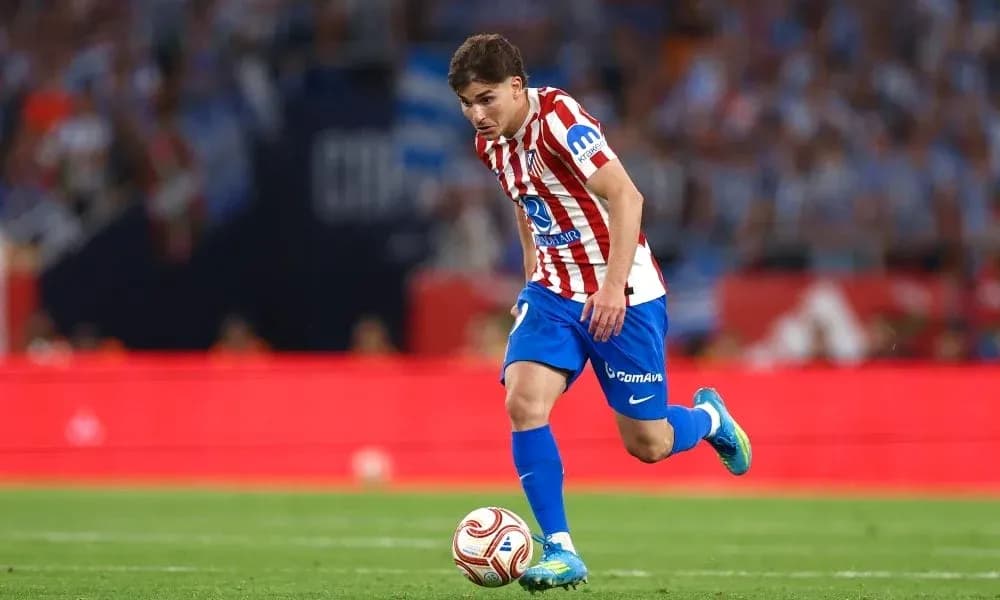 Atletico Madrid player dribbling during a match Atletico Madrid player dribbling during a match