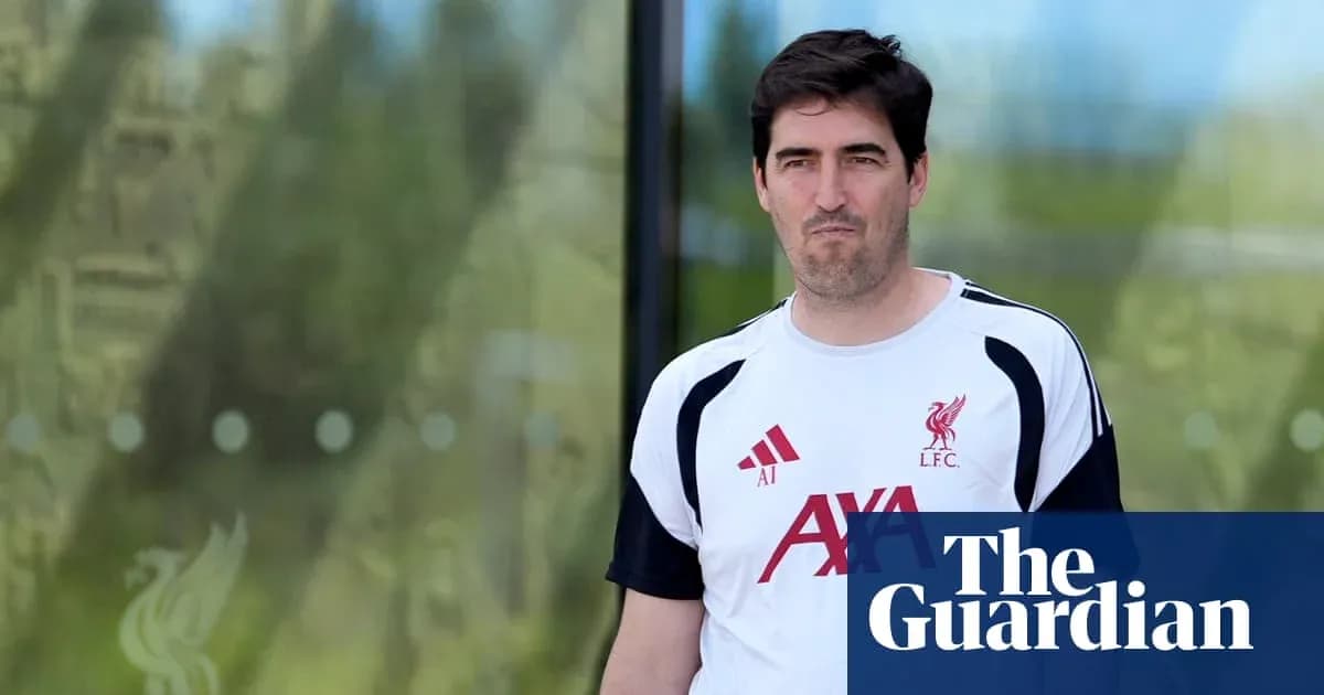 Man in Liverpool FC training kit walking outdoors Man in Liverpool FC training kit walking outdoors