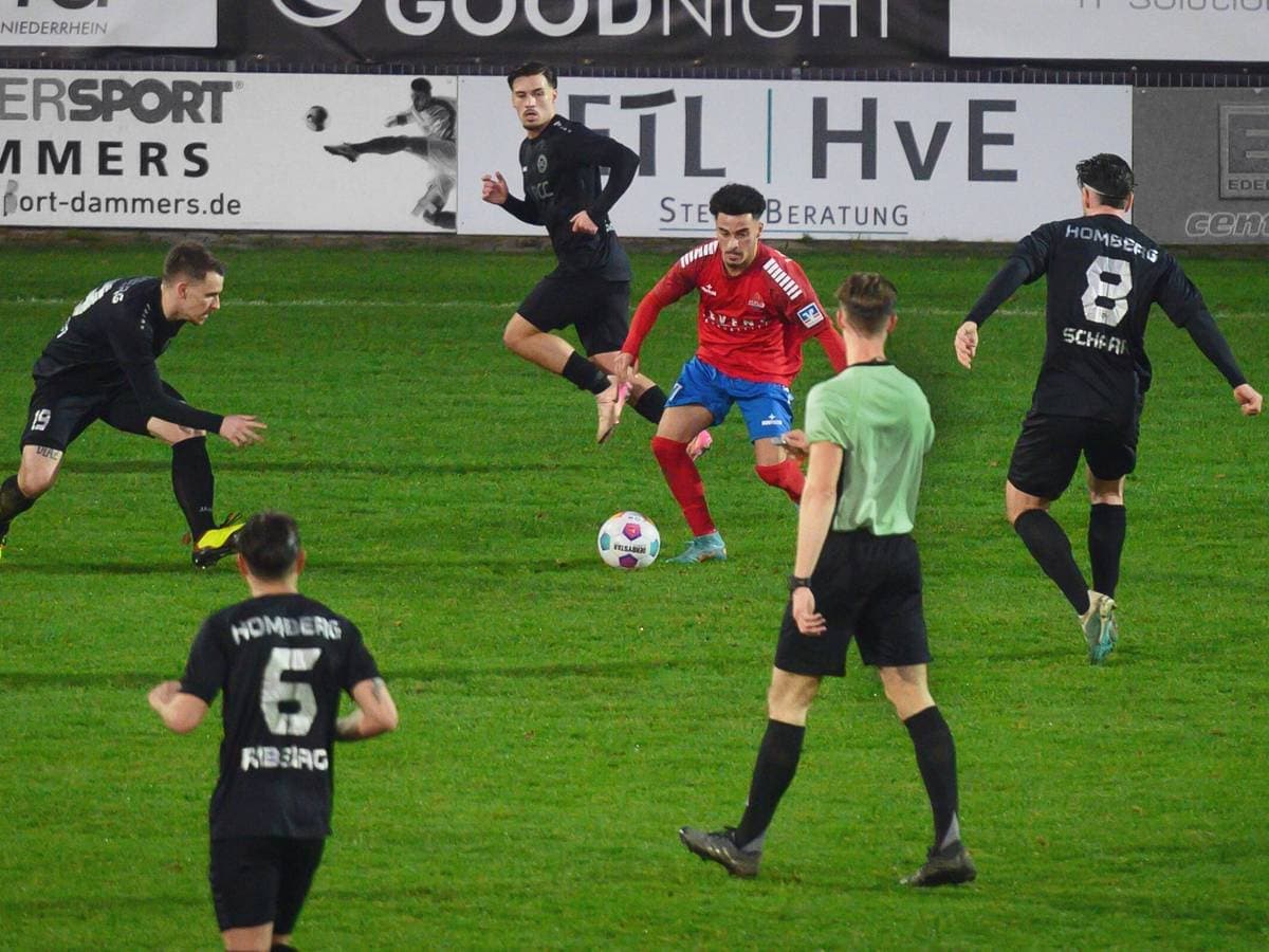 Players competing for the ball in football match Players competing for the ball in football match