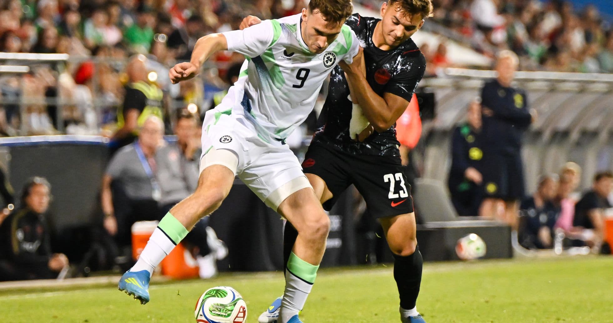 Two players competing for the ball during match Two players competing for the ball during match