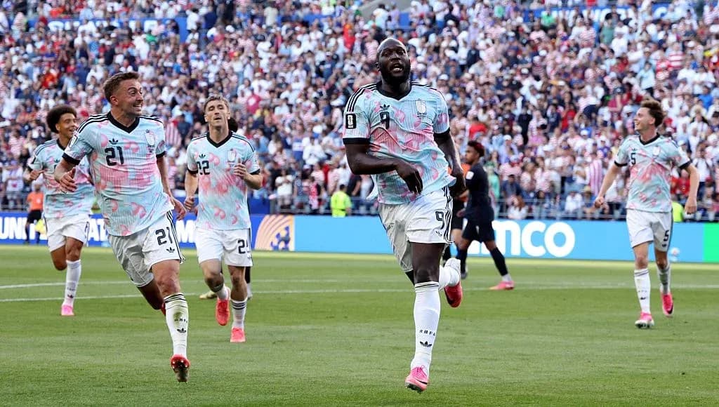 Players celebrating a goal during a soccer match Players celebrating a goal during a soccer match