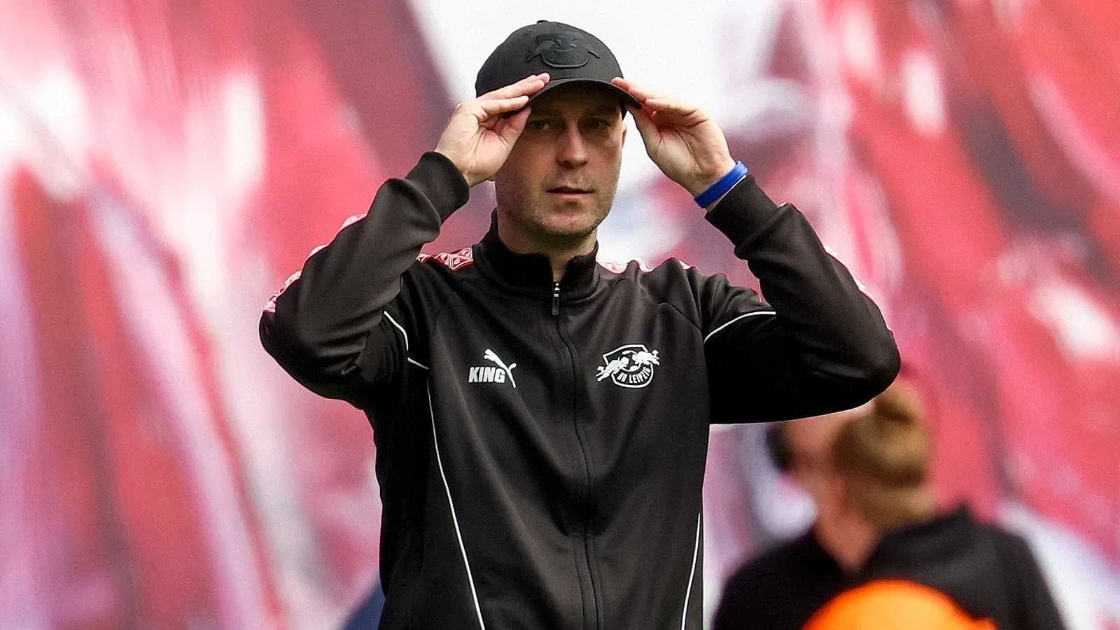 Coach adjusting cap during a match on the sidelines Coach adjusting cap during a match on the sidelines