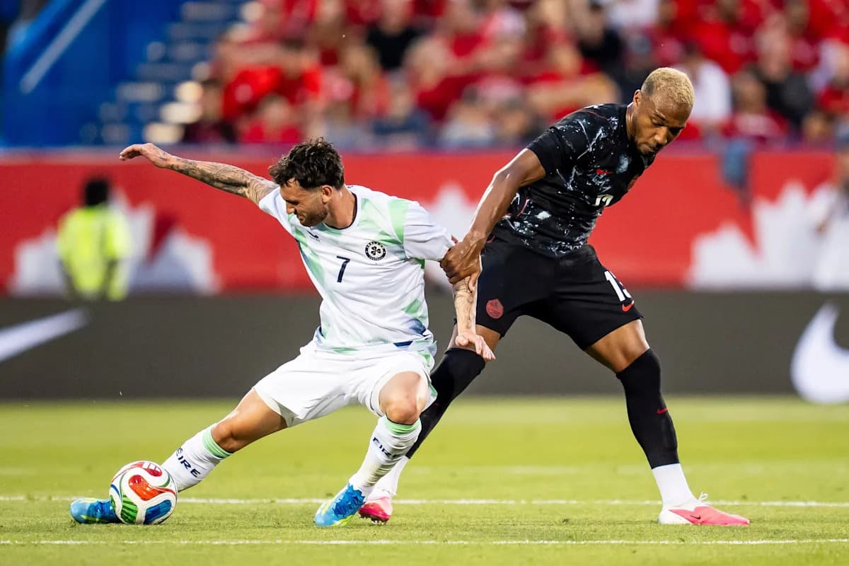 Two players contesting for the ball on the field Two players contesting for the ball on the field