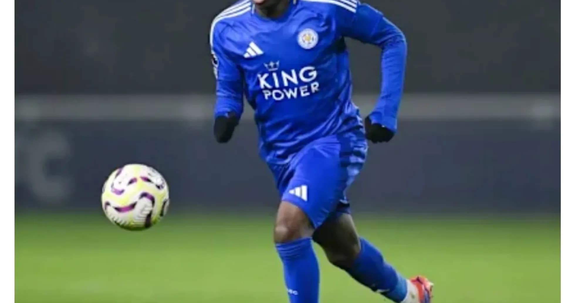 Player in blue kit running with the ball Player in blue kit running with the ball