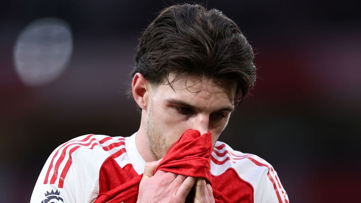 Player holding shirt to face in disappointment Player holding shirt to face in disappointment