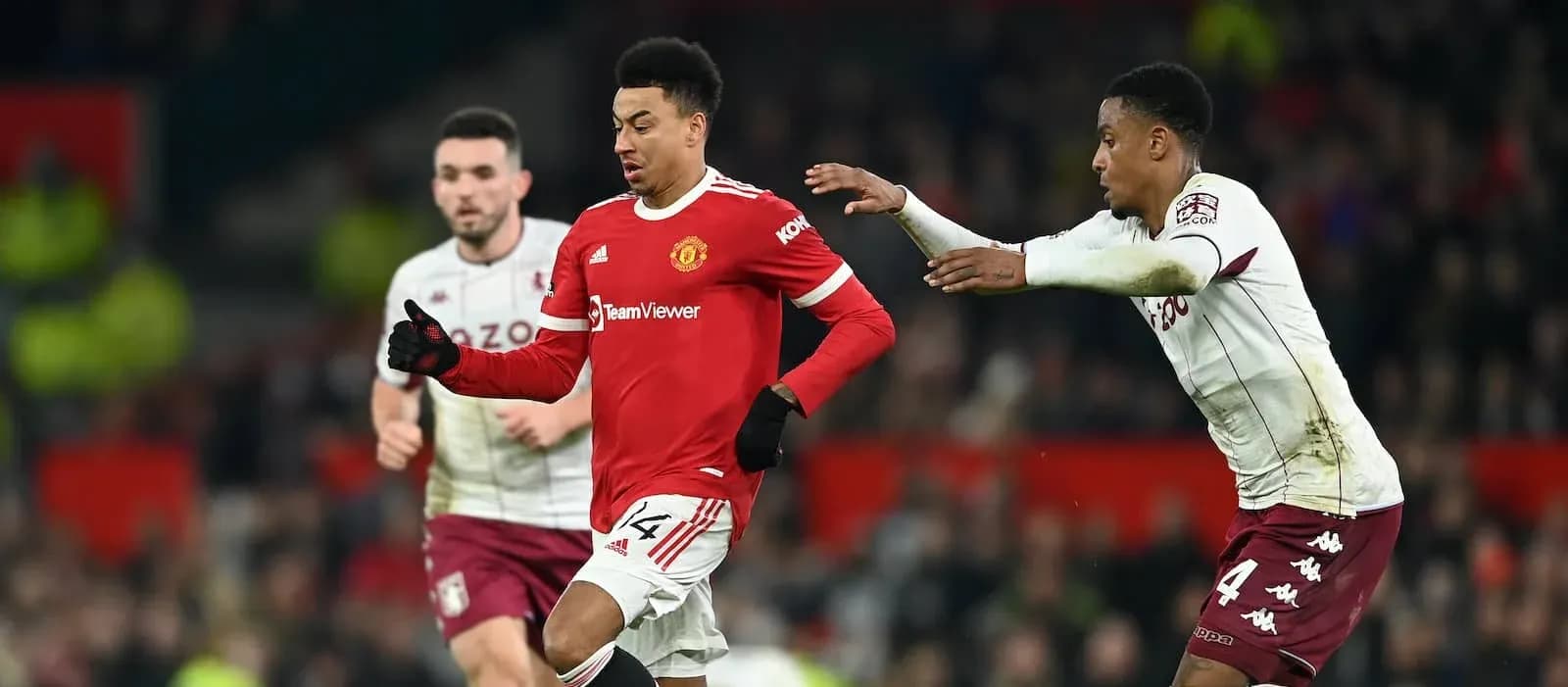 Manchester United player dribbling past Aston Villa defenders Manchester United player dribbling past Aston Villa defenders