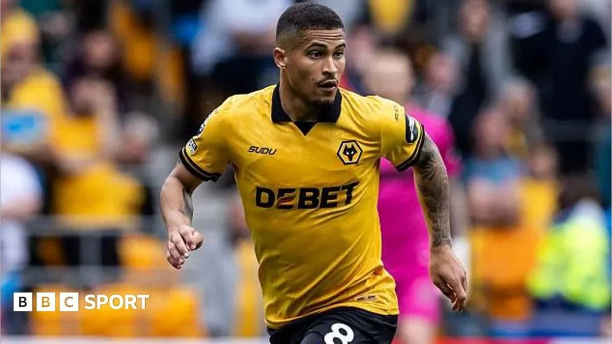 Player in yellow Wolves jersey running on field Player in yellow Wolves jersey running on field