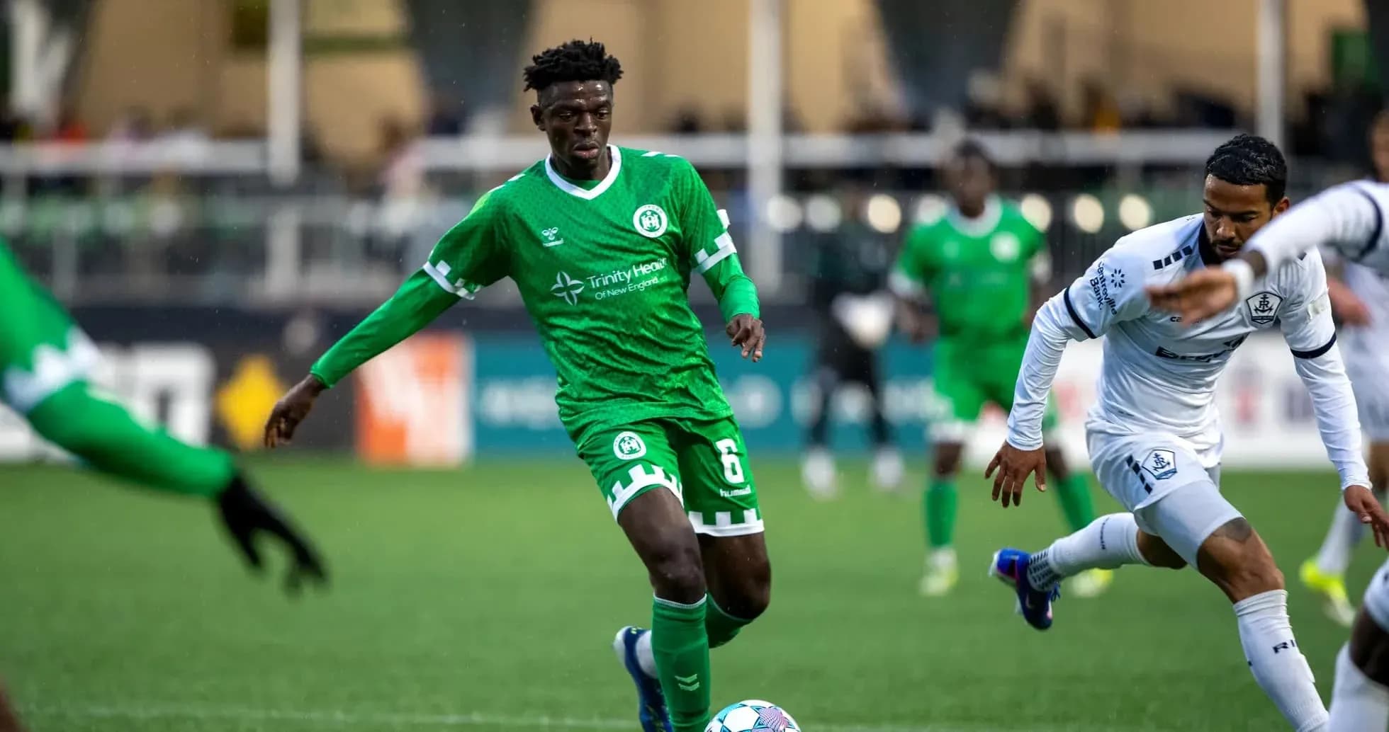 Player dribbling the ball in green jersey Player dribbling the ball in green jersey