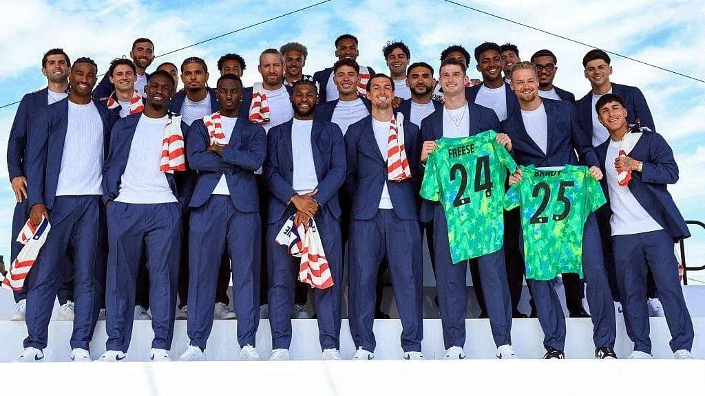 Soccer team posing in suits with jerseys Soccer team posing in suits with jerseys