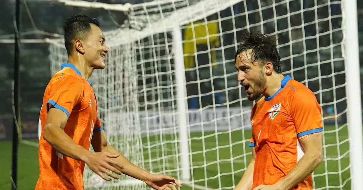 Two players celebrating a goal in orange jerseys Two players celebrating a goal in orange jerseys