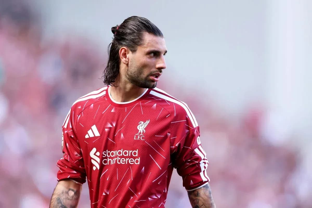 Goalkeeper wearing Liverpool jersey on the pitch Goalkeeper wearing Liverpool jersey on the pitch