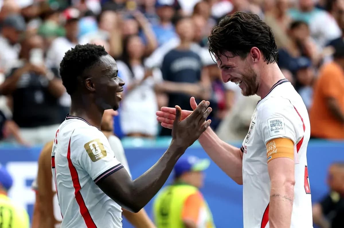 Two players celebrating on the pitch after match Two players celebrating on the pitch after match