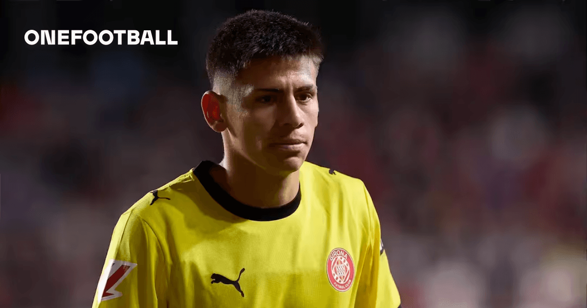 Goalkeeper wearing yellow jersey walking on the field Goalkeeper wearing yellow jersey walking on the field