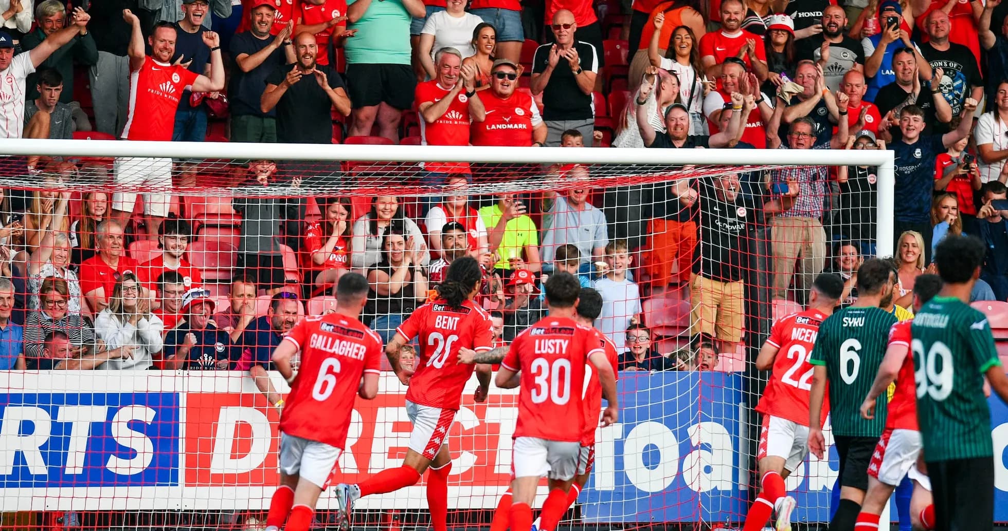 Larne fans celebrating a goal during match Larne fans celebrating a goal during match