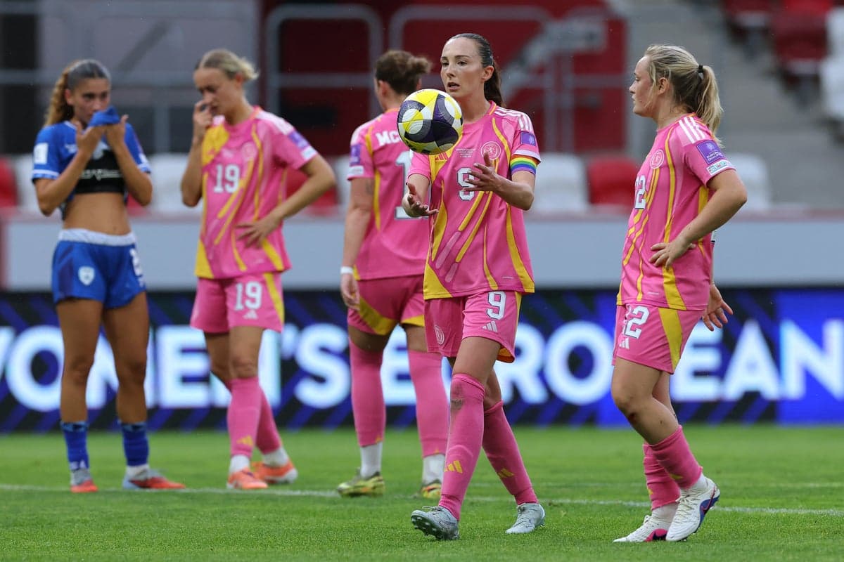 Players in pink uniforms during a women's football match Players in pink uniforms during a women's football match