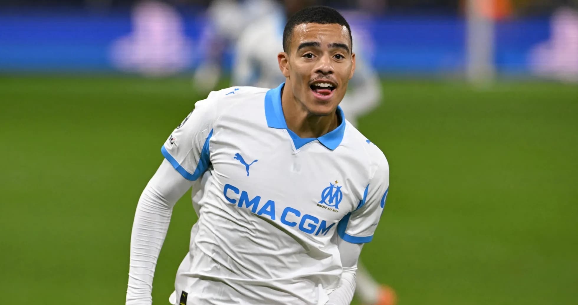 Player celebrating a goal in Marseille jersey Player celebrating a goal in Marseille jersey