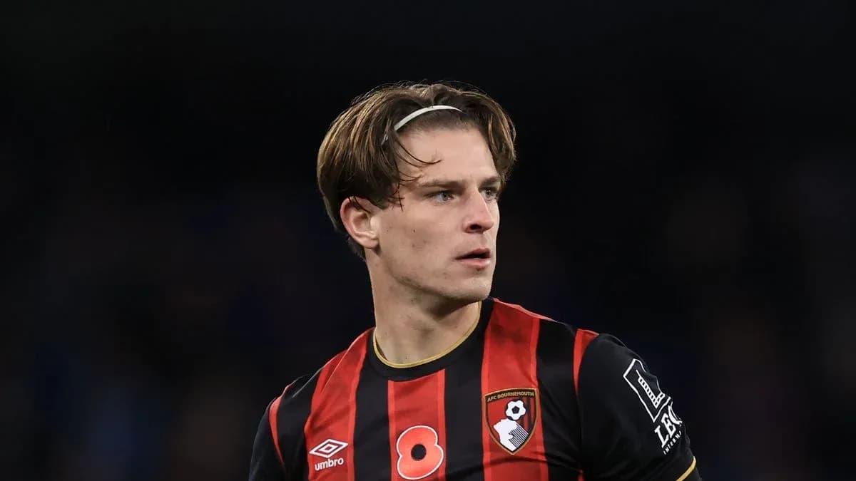 Bournemouth player in black and red jersey on field Bournemouth player in black and red jersey on field