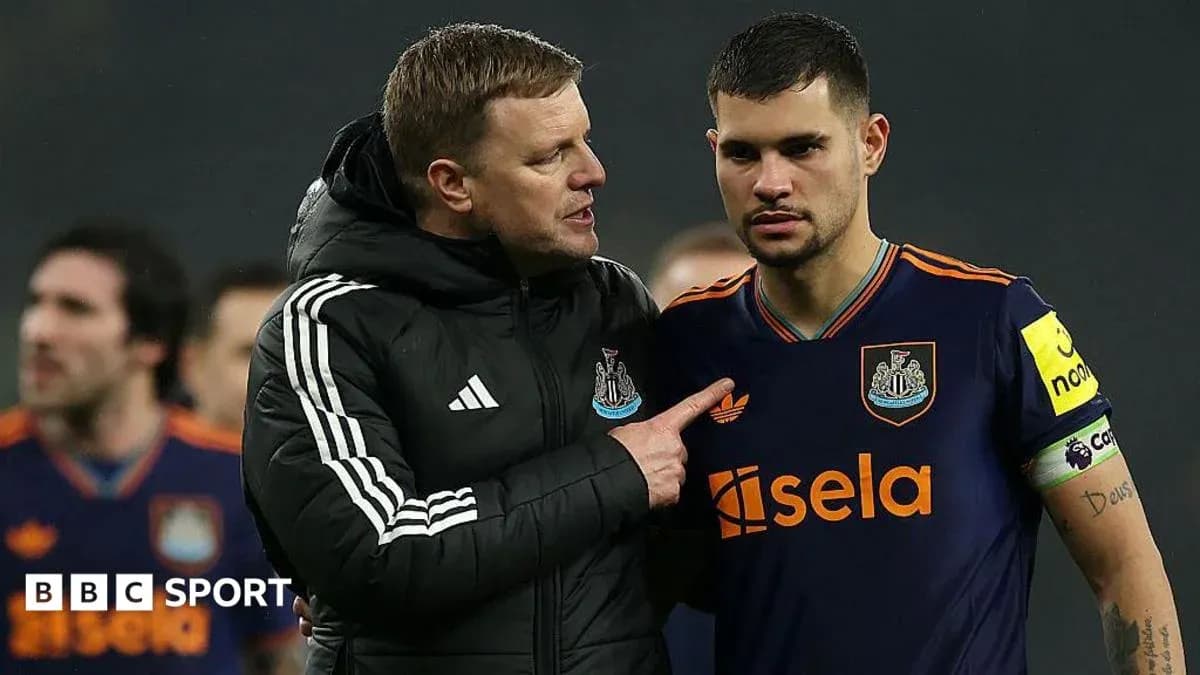 Manager discussing strategy with player on pitch Manager discussing strategy with player on pitch