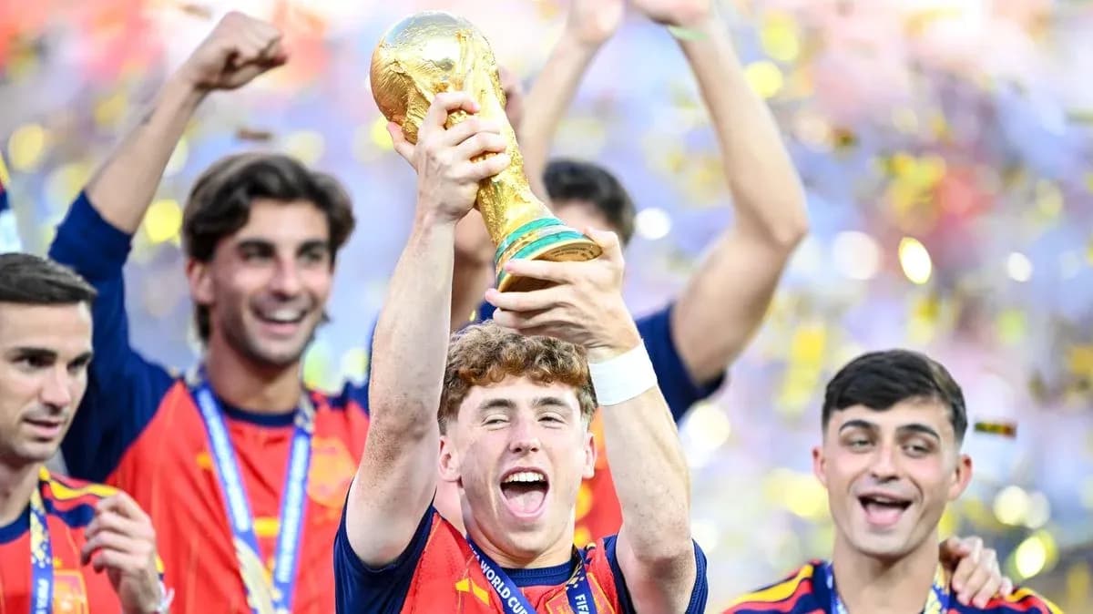 Player celebrating with FIFA World Cup trophy surrounded by teammates Player celebrating with FIFA World Cup trophy surrounded by teammates