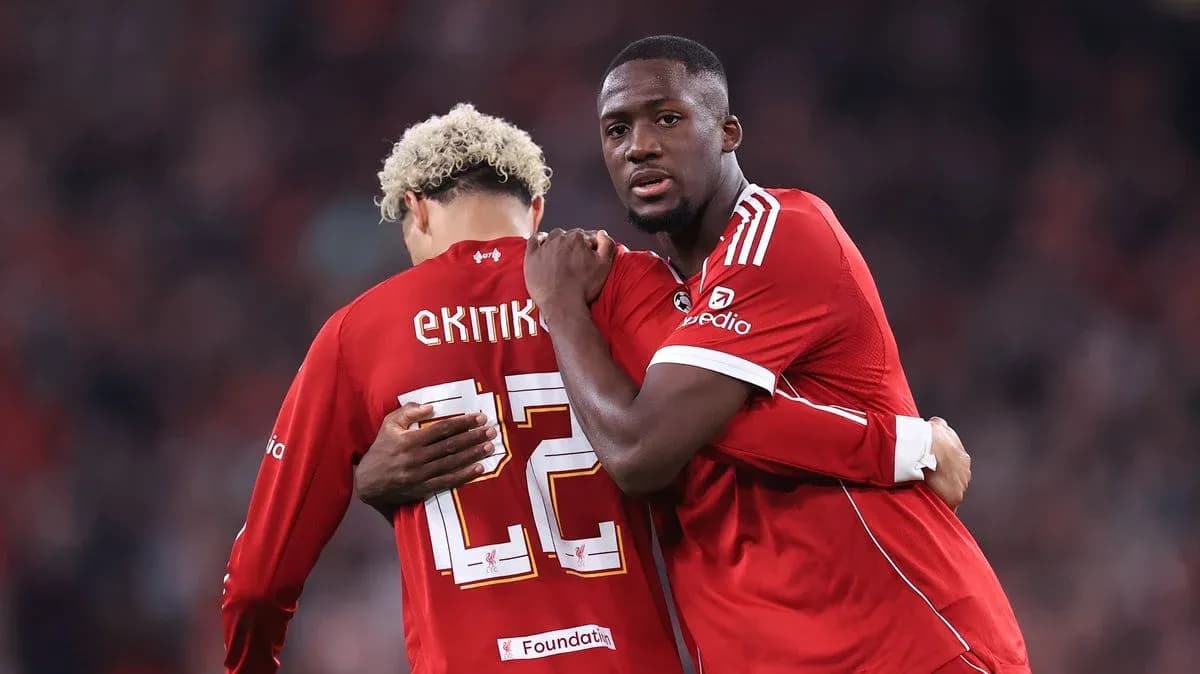 Two players in red jerseys embracing during match Two players in red jerseys embracing during match