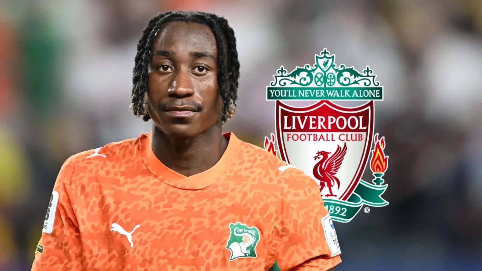 Player in orange jersey with Liverpool logo background Player in orange jersey with Liverpool logo background