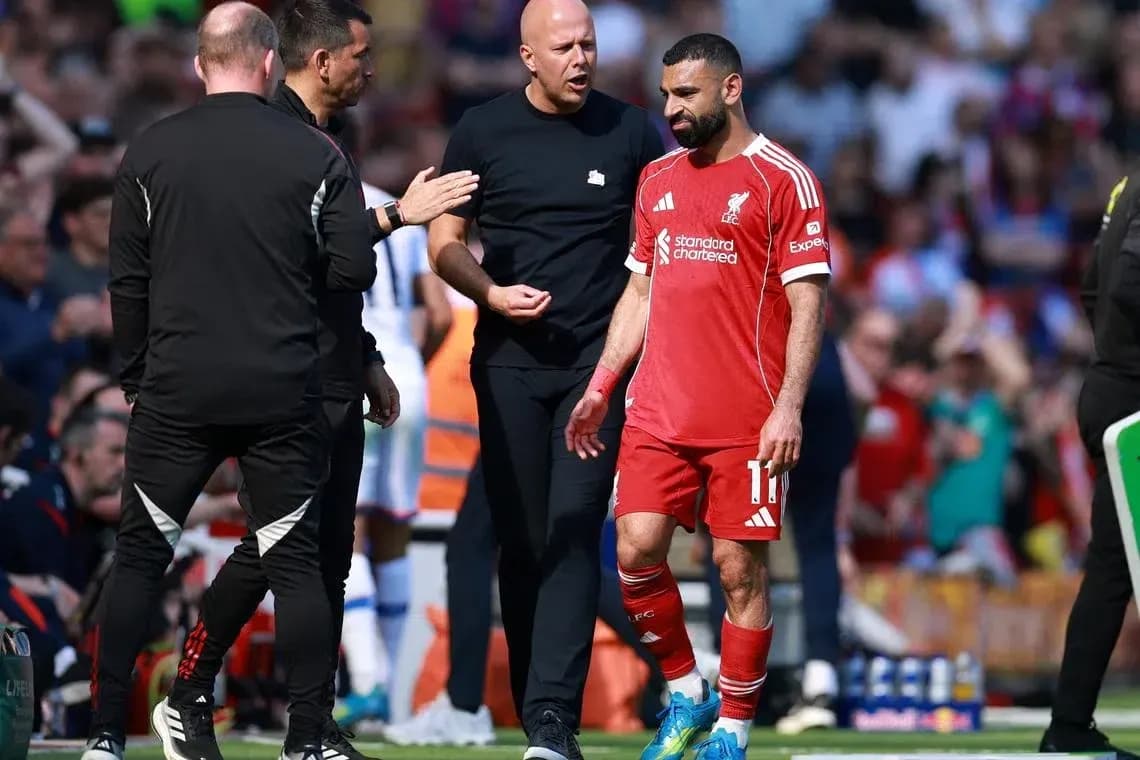 Mohamed Salah leaving the pitch with staff during match Mohamed Salah leaving the pitch with staff during match