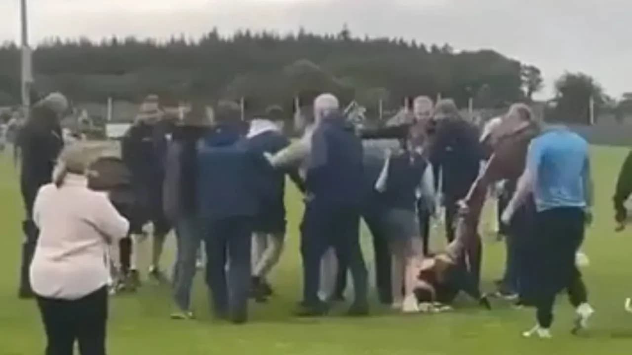 Crowd gathered around players on the field Crowd gathered around players on the field