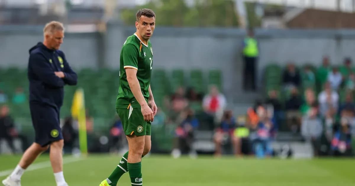 Player in green kit during training session on pitch Player in green kit during training session on pitch