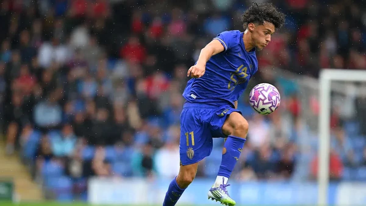 Player in blue kit controlling a soccer ball Player in blue kit controlling a soccer ball